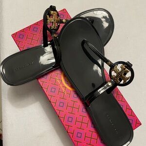 Tory Burch Black and Gold Sandals.